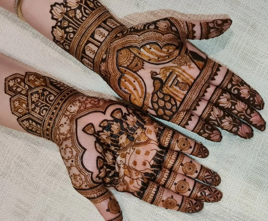 traditional rajasthani mehndi with cows and peacock on both palms for wedding guest look